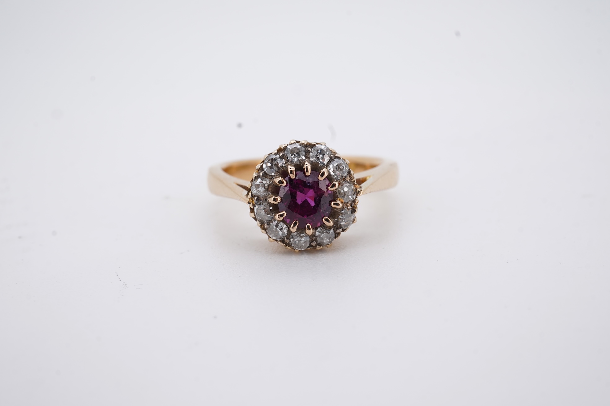 A George V 18ct gold, ruby and diamond set circular cluster ring, size M, gross weight 5 grams.